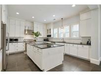 Bright kitchen features a large island, stainless steel appliances, and white cabinets at 200 Edinburgh Ln, Woodstock, GA 30188