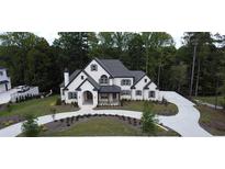 Stunning two-story home featuring a circular driveway and beautifully landscaped front yard at 583 Carl Sanders Dr, Acworth, GA 30101