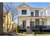 Charming two-story home with white siding, black trim and a welcoming front porch at 593 Formwalt Sw St, Atlanta, GA 30312