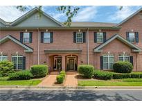 Charming brick townhome exterior featuring well-manicured landscaping and inviting front entrances at 1950 Buford Dam Rd # 105, Cumming, GA 30041