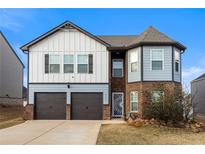 Charming two-story home with brick and siding, two-car garage and landscaped front yard at 1805 Marcelina Ln, Mcdonough, GA 30253