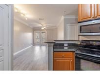 Inviting living room featuring hardwood floors and sliding glass doors to outdoor balcony at 10 Perimeter Summit Ne Blvd # 3204, Atlanta, GA 30319