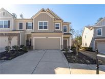 Charming two-story townhouse featuring a two-car garage and well-maintained landscaping at 5512 Cascade Sw Run, Atlanta, GA 30336