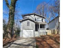 Charming two-story home with gray siding, attached garage, and a small, covered front porch at 1180 Vickers St, Atlanta, GA 30316