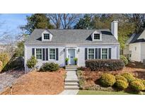 Charming home with a beautifully landscaped front yard, gray roof, and a inviting light-blue front door at 2083 Golfview Dr, Atlanta, GA 30309