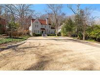 Charming home features red tile roof, manicured yard, and a stately facade at 1122 Springdale Ne Rd, Atlanta, GA 30306