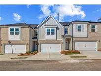 Charming new townhome boasts a one-car garage and stylish exterior finishes at 308 Shine Dr, Stockbridge, GA 30281