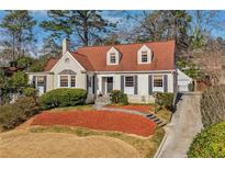 Charming two-story home featuring a well-manicured front yard and red brick accent landscaping at 1108 Berkshire Ne Rd, Atlanta, GA 30306