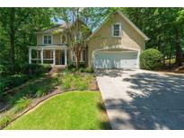 Charming home featuring a covered front porch, well-manicured lawn and an attached garage at 4010 Tamarack Nw Dr, Kennesaw, GA 30152
