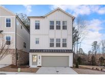 Charming three-story home with white painted brick and siding, a gray garage door, and multiple windows at 120 Pinecone Pkwy, Alpharetta, GA 30022