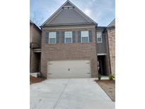 Two story brick home with a 2 car garage and dark shutters on the upper windows at 2677 Pearl Ridge Trce, Buford, GA 30519