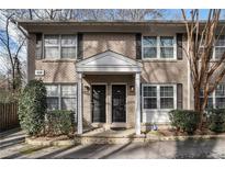 Charming brick townhome with a covered entrance and black shutters at 2232 Dunseath Nw Ave # 302, Atlanta, GA 30318