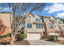 Charming townhome with a two-car garage, brick and stone accents, and manicured landscaping at 506 Glen Ivy # 5, Marietta, GA 30062