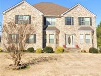 Charming two-story brick home with a well-maintained front yard and beautiful landscaping at 85 Tanglewood Dr, Covington, GA 30016