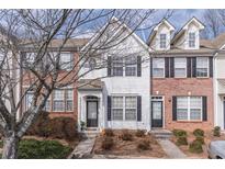 Charming townhome featuring a tidy front yard and a welcoming entrance at 1207 Penhurst Way, Lawrenceville, GA 30043