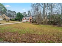Charming two-story home with a brick facade, landscaped yard, and driveway at 4570 Thicket Trl, Snellville, GA 30039