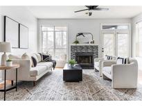 Bright living room features fireplace, modern furniture, and a large window at 1033 Mcgill Park Ne Ave, Atlanta, GA 30312