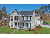 Stunning two-story home with a charming front porch, well-manicured lawn, and beautiful curb appeal at 915 Laurel Brooke Ave, Peachtree City, GA 30269