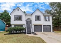 Charming two-story home featuring a manicured lawn and an attached two-car garage at 2954 Lighthouse Ct, Acworth, GA 30101