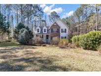 Charming two-story home featuring a brick facade, dormer windows, and a well-maintained front lawn at 245 Bartlett Dr, Sharpsburg, GA 30277