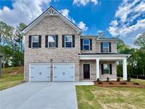 Charming two-story brick home with a two-car garage and well-maintained lawn at 651 Egrets Landing #53, Covington, GA 30014