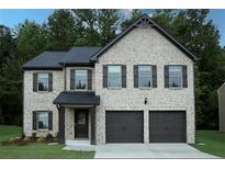 Two story home with white painted brick and a two car garage at 651 Egrets Landing #53, Covington, GA 30014