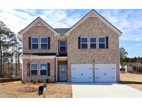 Charming two-story brick home with a well-manicured front yard, perfect for suburban living at 642 Egrets Landing #66, Covington, GA 30014