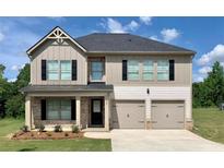 Charming two-story home featuring a welcoming front porch and a two-car garage at 643 Egrets Landing Lndg, Covington, GA 30014