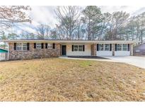 Charming brick ranch home with a well-maintained lawn and classic curb appeal at 3884 Rockey Valley Dr, Conley, GA 30288