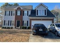 Charming two-story home featuring a brick facade and a well-maintained front yard at 232 Rockingham Dr, Loganville, GA 30052