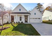 Charming home with a well-manicured lawn, covered porch, and a two car garage at 1100 Cooks Farm Way, Woodstock, GA 30189