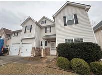 Charming two-story home with two-car garage, stone accents and lush landscaping at 4416 Water Mill Dr, Buford, GA 30519