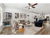 Spacious living room featuring an open floor plan, modern decor, and beautiful hardwood floors at 511 Burton Dr # 805, Alpharetta, GA 30009