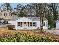 Charming single-story home features a cozy front porch and well-maintained landscaping at 1906 Turpin Se Rd, Smyrna, GA 30080