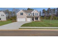 Charming new two-story home featuring a three-car garage, gray brick and siding, and a well-manicured lawn at 112 Felicity Pike, Locust Grove, GA 30248