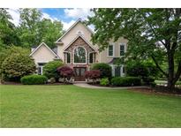 Charming two-story home with stone accents, manicured lawn and mature trees at 1850 Kirkmont Nw Dr, Marietta, GA 30064