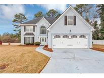Charming two-story home features a two-car garage, manicured lawn, and classic architectural details at 5705 Mountain Cres, Stone Mountain, GA 30087