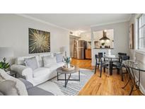 Inviting living room with a comfortable white couch, stylish decor, and an open flow to the kitchen at 798 Saint Charles Ne Ave # 5, Atlanta, GA 30306