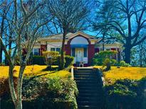 Charming one-story home featuring brick accents, mature trees, and a welcoming front yard at 1948 Mercer Ave, College Park, GA 30337