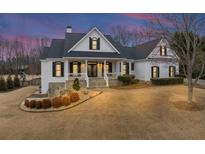 Beautiful two-story home with a manicured lawn and charming curb appeal featuring a stone foundation at 102 Rosebury Dr, Canton, GA 30115