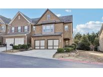 Two-story brick home with a two-car garage, manicured landscaping, and a welcoming front entrance at 220 Ashley Se Ln # 19, Smyrna, GA 30080