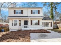 Charming two-story home featuring a welcoming front porch and manicured lawn at 594 Waynes Se Ct, Atlanta, GA 30354
