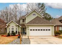 Charming two-story home with attached garage, landscaped front yard, and beautiful curb appeal at 1046 Ashbury Dr, Decatur, GA 30030