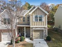 Charming two-story home with stone accents, a one-car garage, and manicured landscaping at 106 Oakview Psge, Canton, GA 30114