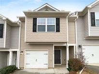 Attractive townhome with gray siding, black shutters, a white garage door, and a covered front porch at 1112 Highwood Ln, Atlanta, GA 30344