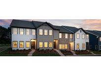 Exterior view of newly built townhomes with varied facades and professionally landscaped yards at 2107 Stillhaven Pl, Douglasville, GA 30135