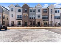 Charming townhomes with a brick and siding facade, black trim, and well-manicured landscaping at 355 Walker Avenue, Roswell, GA 30076