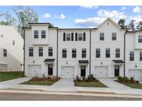 Charming townhomes with a classic white facade, black shutters, and well manicured lawns at 3162 Washburn Sw St, Atlanta, GA 30354