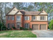 Beautiful two-story brick home featuring a two-car garage and a well-manicured front yard at 2552 Forest Meadow Ln, Lawrenceville, GA 30043