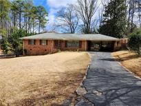Charming single-story brick home with a covered carport and a long driveway at 5535 Beaver Sw Dr, Mableton, GA 30126